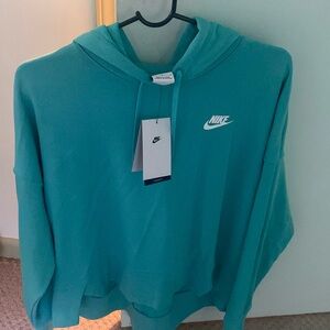 New with tags Nike hoodie in a teal color! Womens large and never worn before.